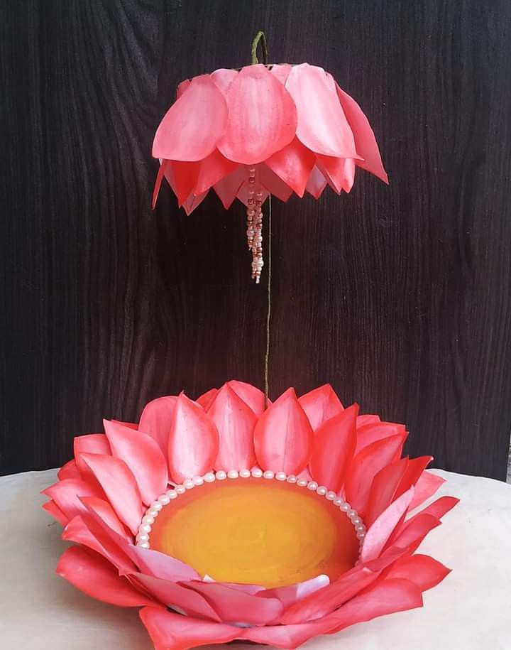 a pink flower sitting on top of a white table