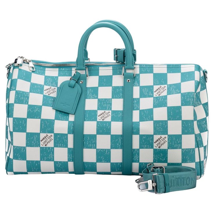 This Keepall Bandoulière 45 bag is fashioned from leather with a Damier checkerboard pattern in teal and white. The leather top handles, side bands, and nametag are also in teal. The squares look as if they were drawn and filled in with a colored pencil. The Vuitton signature in certain squares also has a hand-drawn aspect. The bag comes with a shoulder strap which has a maximum length of 19.6'. It includes original dust cover and box. Louis Vuitton Luggage, Checkerboard Pattern, Dust Cover, Colored Pencil, Leather Top, Travel Luggage, Fashion Handbags, Louis Vuitton Damier, Travel Bag