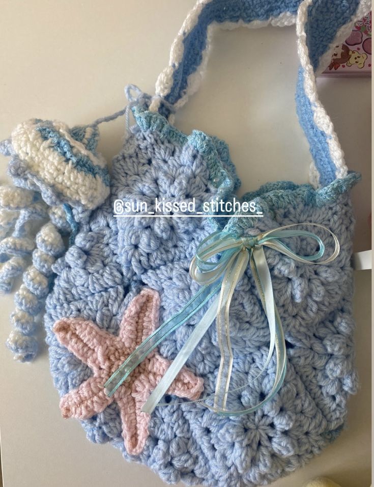 a crocheted bag with two starfishs on it