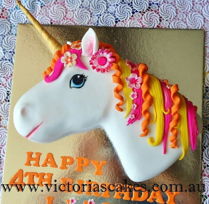 a birthday cake decorated with an unicorn's head