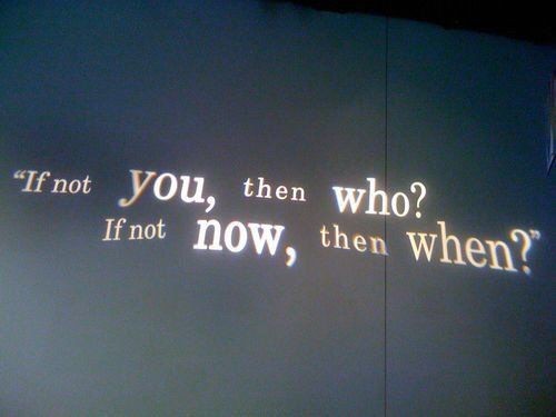 the words are projected on the wall in front of it's light fixture, which reads do you, then who? if not now, then when