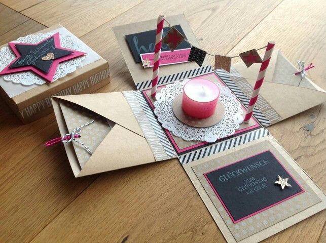 a table topped with cards and candles on top of a wooden floor next to boxes