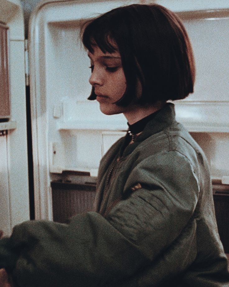 a woman is standing in front of an open refrigerator with her eyes closed and hands on the door