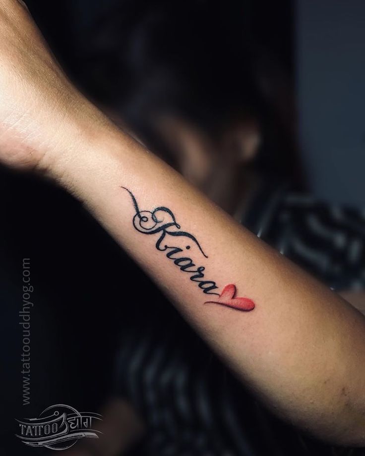 a man with a tattoo on his arm that reads, love and is in cursive writing