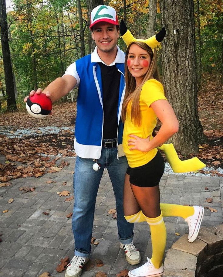 a man and woman in pokemon costumes posing for a photo