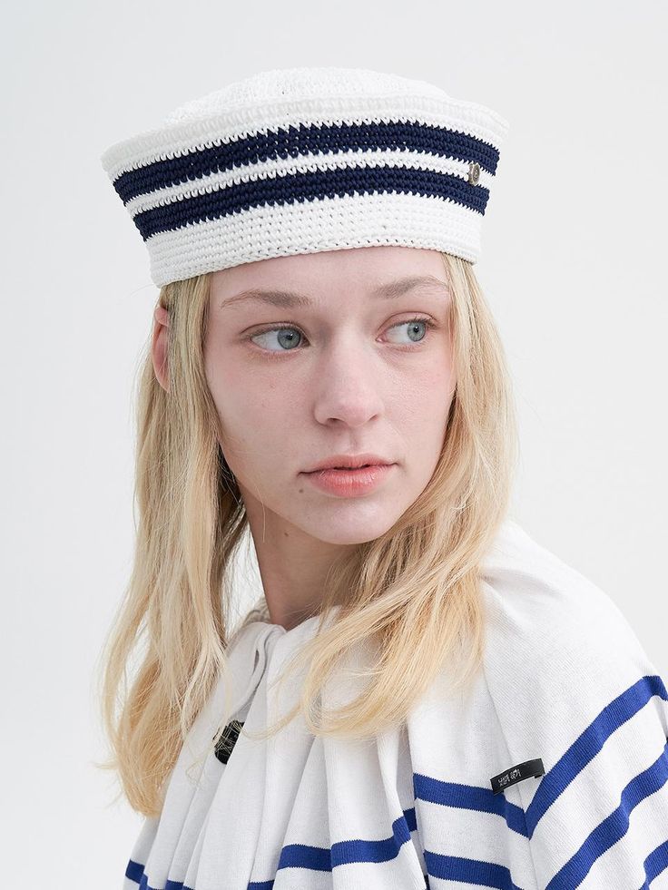 a woman with blonde hair wearing a sailor's hat