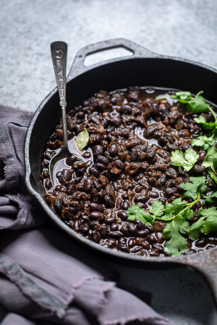 a skillet filled with beans and cilantro