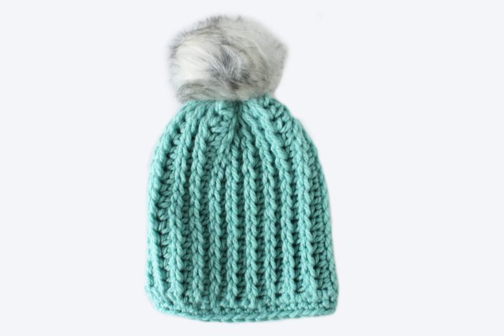 a knitted hat with a fur pom