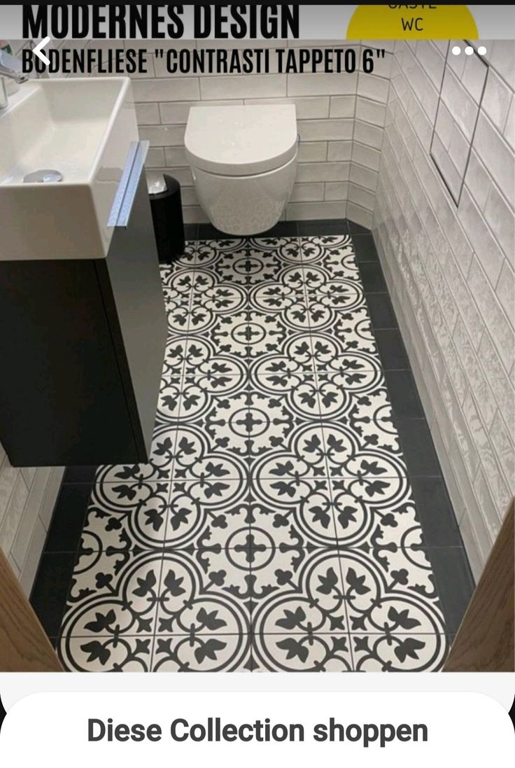 a bathroom with black and white tiles on the floor