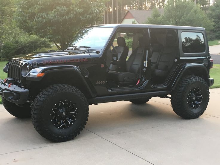 a black jeep is parked in the driveway