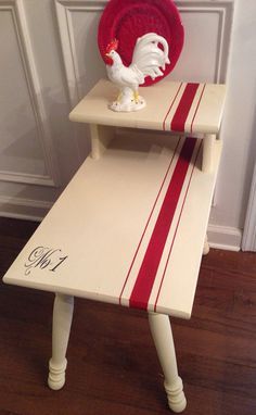 a small white table with red and white stripes on it