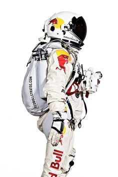 a man in an astronaut's suit and helmet is standing with his back to the camera