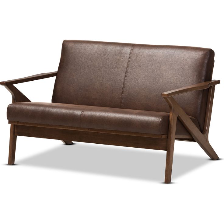 a brown leather couch with wooden arms