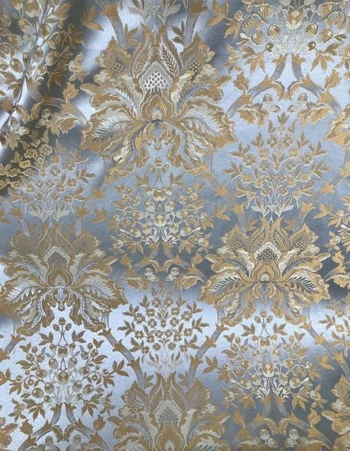 a gold and silver wallpaper with an intricate design on it's surface,