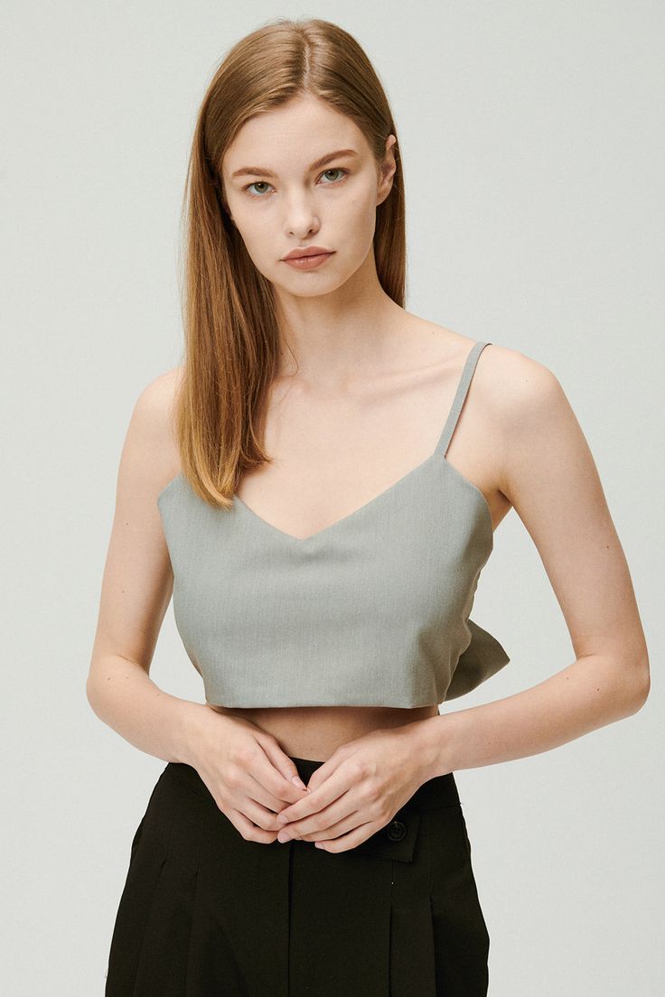 Sleeveless top Adjustable tie Crop length Unlined 60% Polyester 36% Rayon 4% Span Professional Clean Only / Do Not Tumble Dry Top: Bust: 47.5cm (18.7in) / Length: 23cm (9.1in) /Tie: Length: 85cm (33.5in) / Model's height is 7′ 5″ (170cm) Bust 32.5in Waist 23.5in Hip 34in and wearing Top Made in Korea 사이즈 정보Size information (단위:cm)(Unit : inch) FREETop 사이즈 정보 Size information 가슴Bust 47.518.7 총장Length 239.1 XTie 사이즈 정보 Size information 총장Length 8533.5 - 위의 실측사이즈는 '단면의 길이'입니다. 참고해 주세요.- 사이즈는 측정방법에 따라 1~3cm 정도 오차가 있을 수 있습니다.- 제품색상은 사용자의 모니터의 해상도에 따라 실제 색상과 다소 차이가 있을 수 있습니다. - The above measurement size is'length of section'. please note.- Depending on the measurement method, there may be an error of 0.5~1inch.- The product color may differ slightly from the actual color depending on the resolu Gray Sleeveless Crop Top For Summer, Elegant Summer Vest Crop Top, Chic Cami Vest For Spring, Gray Stretch Summer Camisole, Spring V-neck Tie Back Tank Top, Gray Stretch Camisole For Summer, Summer Stretch Gray Camisole, Chic V-neck Top With Tie Straps, Elegant Cropped Tank Top For Spring