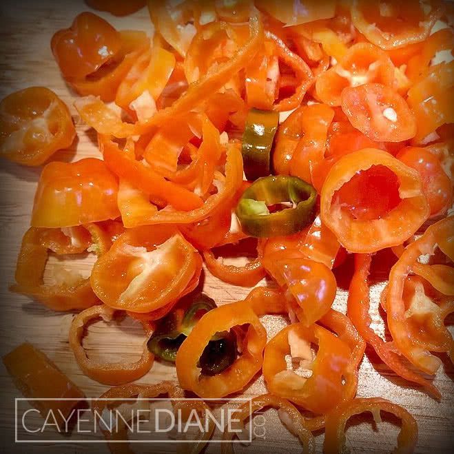 sliced tomatoes and peppers on a cutting board with the words cayenneddinene