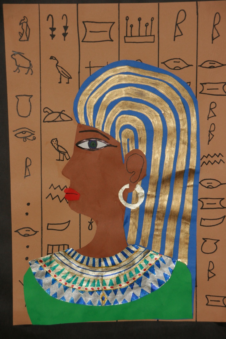 an egyptian woman's head with gold and blue stripes on the wall behind her