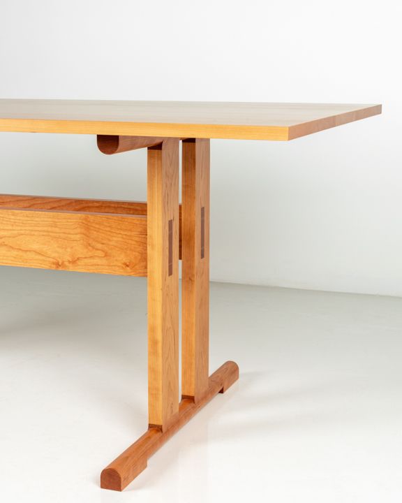 a wooden table sitting on top of a white floor