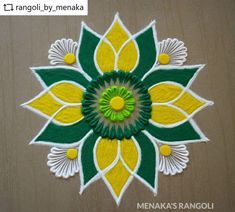 an intricately designed paper work with yellow and green flowers on the center, surrounded by white petals