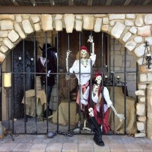 two skeletons are behind bars in a jail cell