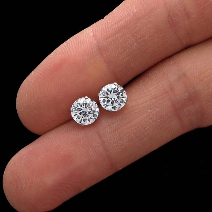 Elegant solitaire earrings featuring round cut brilliant moissanites. Heavy basket settings with double secure screw-back fastenings, all crafted from solid 14k gold. High polished finish makes these classy earrings very bright and eye catching. **Fast & Free US Shipping** 30-Days Money Back Guarantee Our moissanites feature ideal cut, brighter D color and VVS1 clarity making them visually indistinguishable from natural diamonds that cost thousands of dollars. Every diamond comes with a lifetime Anniversary Diamond Earrings With Tension Setting, Fine Jewelry Round Diamond Earrings With Tension Setting, Fine Jewelry Diamond Earrings With Tension Setting, Gift Round Diamond Earrings With Tension Setting, Anniversary Cubic Zirconia Diamond Earrings With Tension Setting, Diamond Earrings With Tension Setting, Diamond White Earrings With Tension Setting In Round Cut, Cubic Zirconia Diamond Earrings With Tension Setting, Diamond White Cubic Zirconia Earrings With Tension Setting