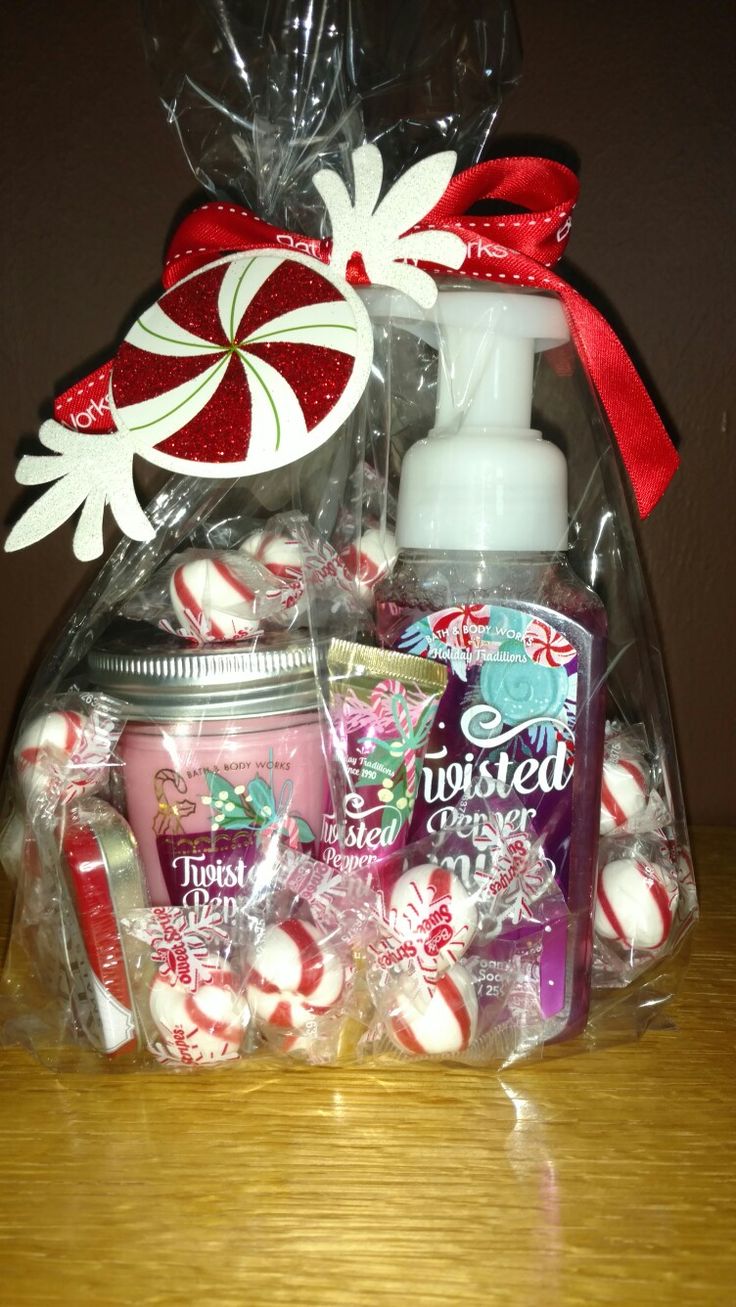 a basket filled with lots of candy canes and other holiday treats on top of a wooden table