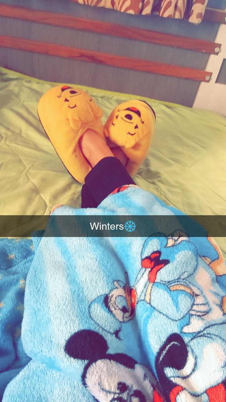 two pictures of someone laying in bed with slippers on their feet and the same person wearing mickey mouse slippers