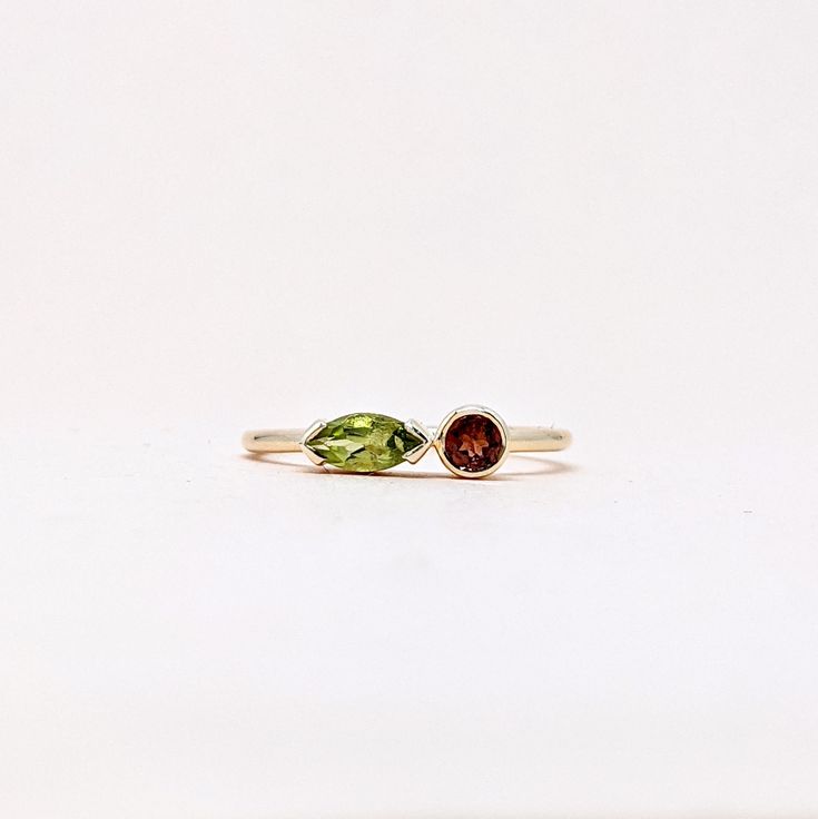 Natural Fine Peridot Garnet Marquise and Round Cut Ring. Semi Precious Gemstone Ring in 14k SOLID GOLD For Her from our Capsule Jewelry Collection. Peridot and Garnet Gemstones are set in  Bezel Setting in our Factory. Gold Ring AA+ Quality. Perfect Gift For Everyday or August Birthstone Gift for Your Loved Ones. ►  DIMENSIONS : ◆ Gemstone : Peridot 0.30 Cts                         : Garnet 0.10 Cts ◆ Stone size : Peridot  6*3 mm                                          : Garnet  3*3 mm ◆ Shank Width : 1 mm      ◆  Material :  14k Yellow Gold          Made to Order      EACH Ring is Stamped With 585 Marked As 14k GOLD International Standard. All my gemstones are hand-selected for best quality assurance, then precisely sawed, and shaped into the desired geometry. The Semi precious stones ar Mixed Gemstone Rings Garnet Peridot And Diamond Heart Shape, Fine Jewelry Marquise Multi-stone Ring, Stackable Peridot Wedding Jewelry, Wedding Jewelry With Peridot Gemstone Accents, Peridot Gemstone Wedding Jewelry, Stackable Peridot Promise Ring, Stackable Peridot Anniversary Jewelry, Fusion Style Promise Ring With Accent Stones, Wedding Stackable Peridot Rings