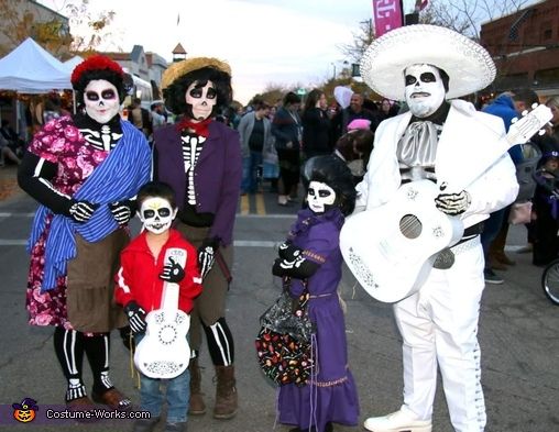 a group of people dressed up as skeletones and skeletons in the middle of a street