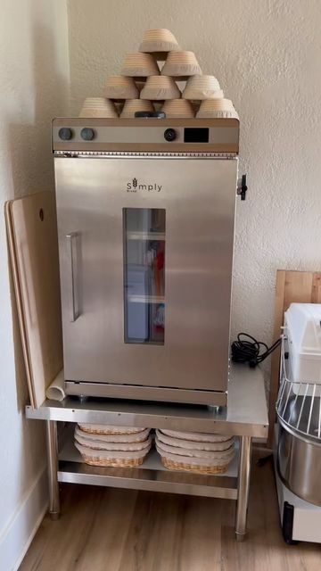 a stainless steel refrigerator sitting on top of a wooden table