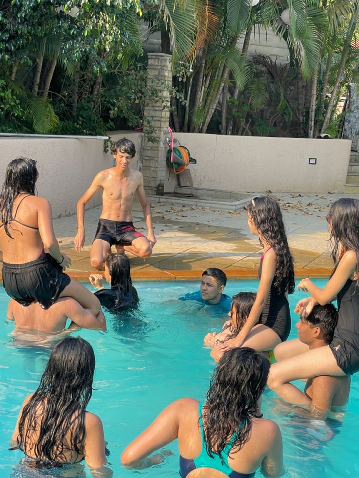 a group of people sitting around in a swimming pool