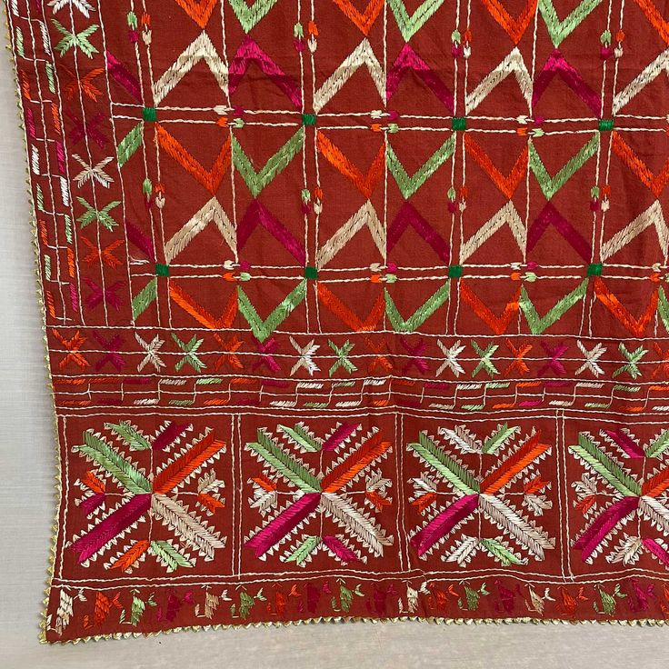 Antique Khadar Bagh is traditional hand embroidered phulkari made for special Punjabi Sikh wedding ceremonies. Mostly used for wedding jaago night, wedding day as a canopy and then gifted to the bride. Khadar Bagh phulkari is a symbol of happiness, prosperity and well being of a woman. Khadar Bagh - Made on hand dyed cotton cloth called khaddar with embroidery of silk threads. Fabric is hand spun and a handloom. Whole surface of the fabric in this bagh has been embroidered in geometric patterns. Red Bohemian Traditional Wear For Ceremonies, Embroidered Multicolor Dupatta For Traditional Ceremonies, Red Embroidered Fabric With Dori Work For Festive Season, Red Embroidered Fabric With Dori Work For Festive Occasion, Red Dupatta With Traditional Patterns For Navratri, Red Embroidered Fabric For Diwali, Embroidered Red Fabric For Diwali, Festive Red Fabric With Dori Embroidery, Red Bohemian Dupatta For Traditional Ceremonies