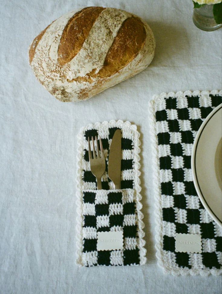 a piece of bread sitting on top of a table next to a fork and knife