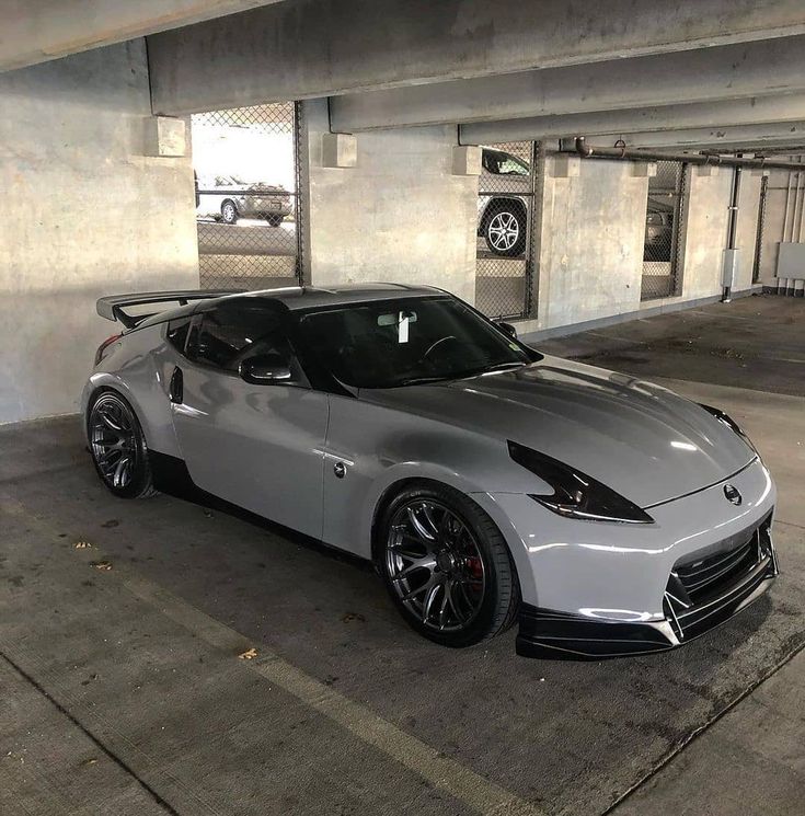 a silver sports car parked in a parking garage