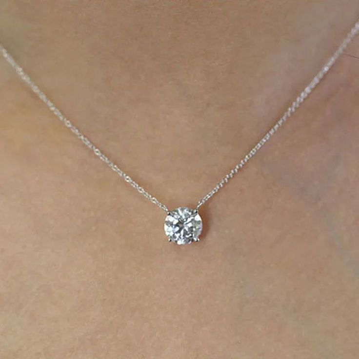 Elevate your elegance with the Solitaire Drop Necklace. This stunning necklace, crafted from 925 Sterling Silver and featuring VVS1 Moissanite, is an exquisite addition to your jewelry collection. Perfect for bridal wear or any special occasion, it radiates the brilliance of D color Moissanite diamonds. Material: 100% 925 Sterling Silver with 18k PVD Gold Plating Stone: D color VVS1 Moissanite (GRA Certified and 100% Diamond Tester Passable) Stone Size: 8mm (2.0 ct) Lightweight and Hypoallergenic Chain Length: 16" GRA Certificate included Why choose moissanite stone? Moissanite is a gemstone that some people choose over diamonds because it's more affordable, more durable and more brilliant. Moissanite is made of silicon carbide, while diamonds are made of carbon. Moissanite has a higher re Dazzling Moissanite Solitaire Necklace For Wedding, Dazzling Moissanite Solitaire Necklace With Diamond Cut, Dazzling Moissanite Solitaire Necklace, Dazzling Moissanite Solitaire Necklace With Prong Setting, Moissanite Solitaire Pendant Necklace With Diamond Accents, Stunning Necklace, Drop Necklace, Moissanite Diamonds, Gifts For Men