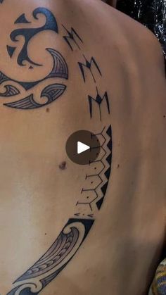 the back of a man with tattoos on his stomach and chest is shown in this video