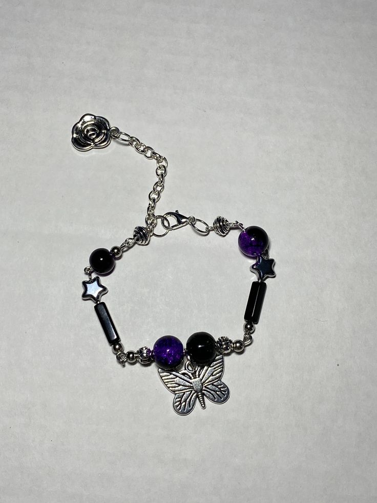 a flowy yet impactful piece, adjustable bracelet, fit for anyone at least 7.5"-8.5". made of glass beads and wire, this would be a perfect gift. Adjustable Metal Bracelet With Butterfly Charm, Adjustable Metal Bracelets With Butterfly Charm, Adjustable Purple Metal Beaded Bracelets, Adjustable Nickel-free Purple Charm Bracelet, Adjustable Beaded Purple Rosary Bracelet, Adjustable Purple Beaded Rosary Bracelet, Adjustable Purple Charm Bracelet, Adjustable Purple Metal Charm Bracelet, Adjustable Purple Metal Crystal Bracelet