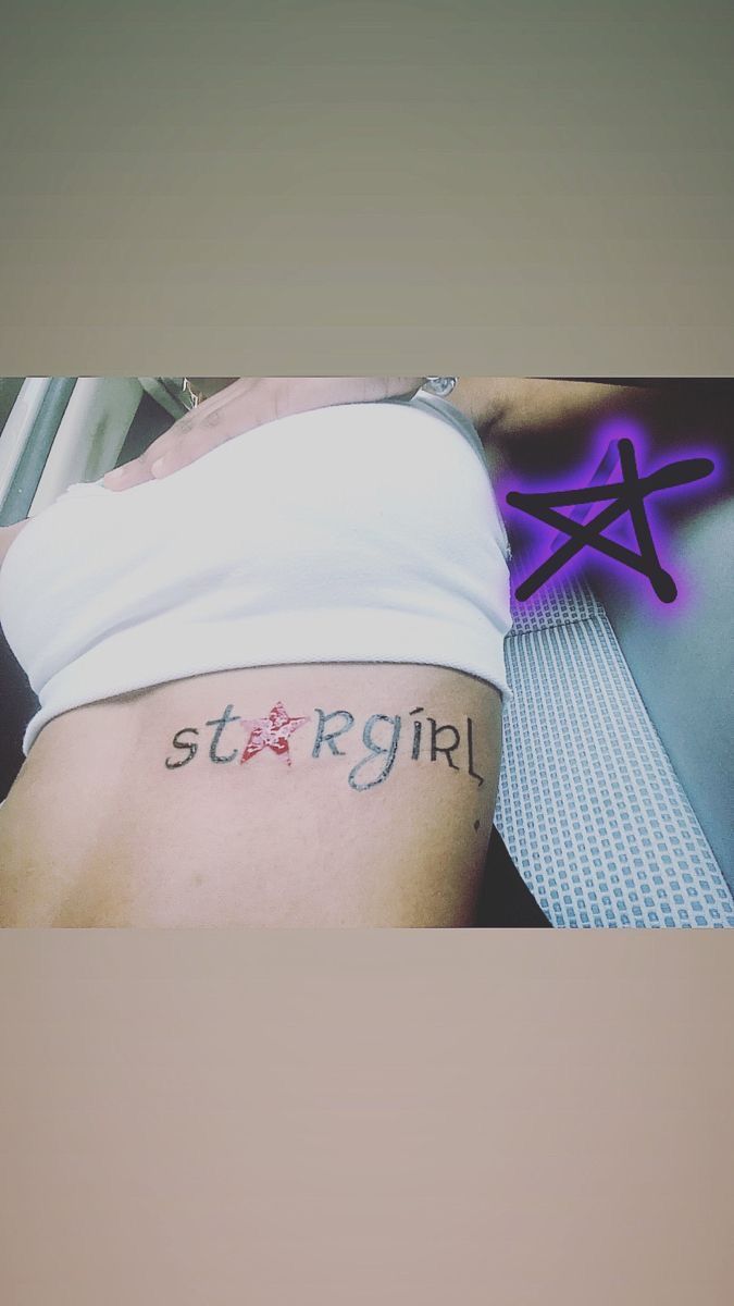 a woman with a star tattoo on her stomach and the words stay right above it