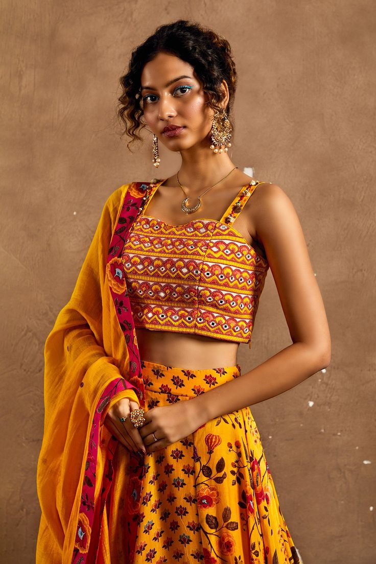 Yellow lehenga with floral, lotus print all over. Paired with mirror, scallop embroidered blouse and dupatta.
Component: 3
Pattern: Printed, Embroidery
Type Of Work: Floral, lotus, mirror, scallop
Neckline: Sweetheart
Sleeve Type: Sleeveless
Fabric: Lehenga and Blouse: Cotton Silk, Dupatta: Chanderi
Color: Yellow
Other Details: 
Strap embroidery
Occasion: Destination Wedding - Aza Fashions Yellow Floral Lehenga, Scallop Neckline, Lehenga And Blouse, Printed Lehenga, Printed Embroidery, Floral Lehenga, Yellow Lehenga, Lotus Print, Blouse Cotton