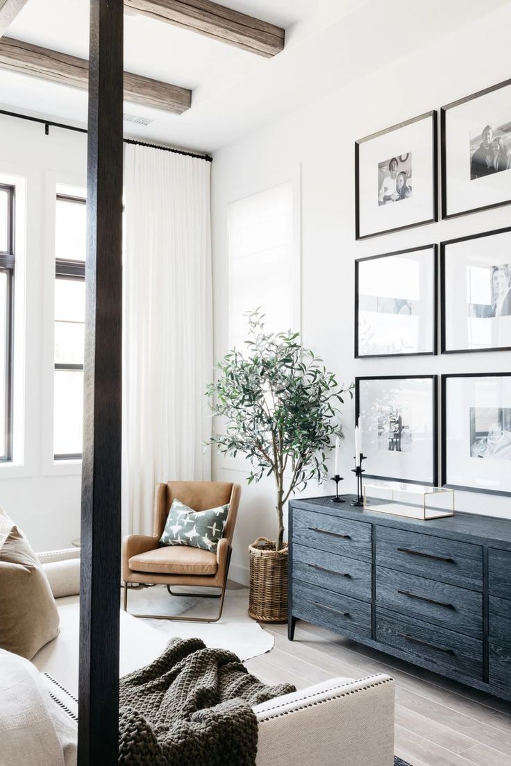 a living room filled with furniture and pictures on the wall