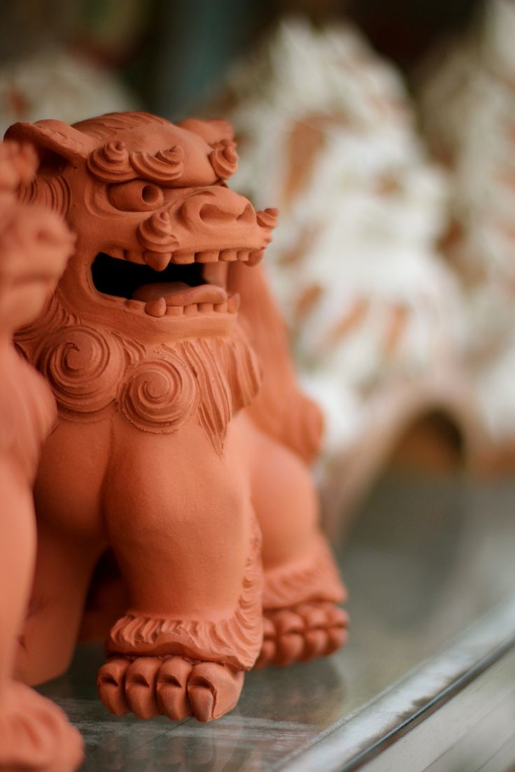 an orange clay animal sitting on top of a table