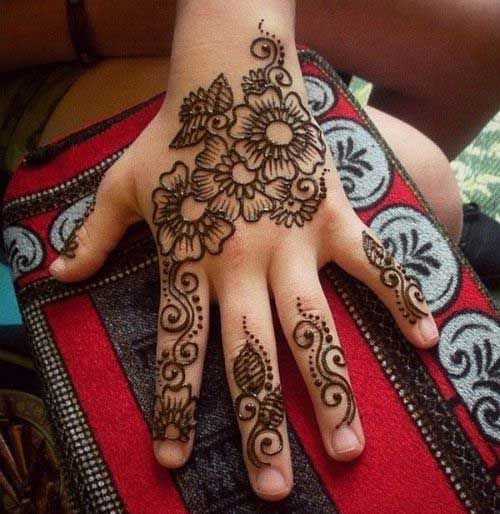 a woman's hand with henna tattoos on it