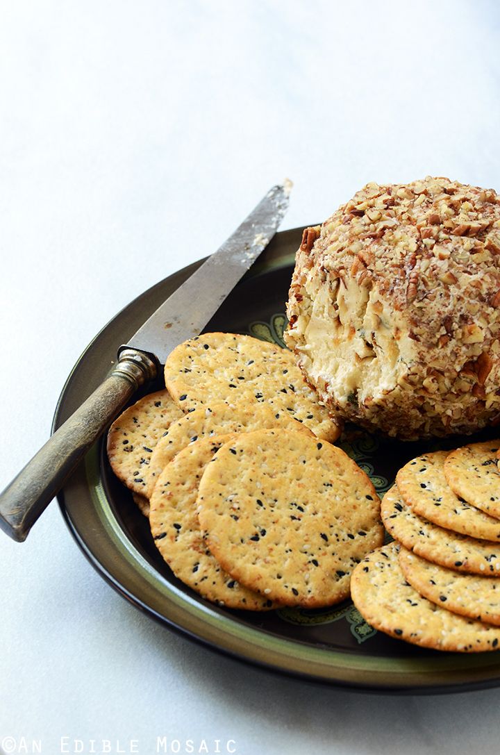 crackers and cheese on a plate with a knife