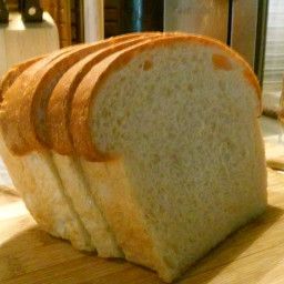 a loaf of bread sitting on top of a wooden cutting board