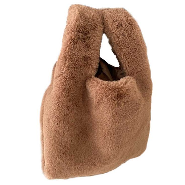 Our Lucia Plush Bag is the perfect bag for cold weather. This small bag features a soft plush fabric and brown satin interior making it warm to hold and easy to clean.Dimensions: 9.4" L x 3" W x 8.7" H (handle is 4.7" H) Fluffy Rectangular Shoulder Bag For Winter, Winter Fluffy Rectangular Shoulder Bag, Winter Fluffy Tote Shoulder Bag, Winter Fluffy Tote Bag, Fluffy Shoulder Bag For Everyday Winter Use, Winter Fluffy Shoulder Bag, Rectangular Bag With Faux Fur Lining For Winter, Winter Bags With Soft Interior For Daily Use, Rectangular Bags With Faux Fur Lining For Winter