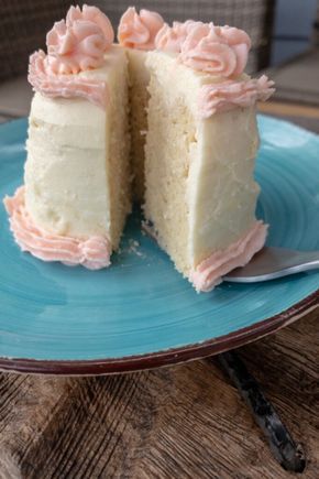 a piece of cake with pink frosting on a blue plate