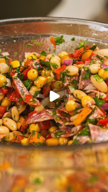 a bowl filled with lots of food on top of a table