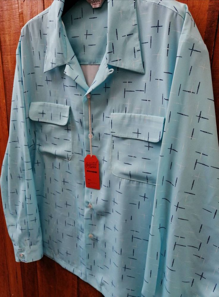 "Taking order now! This beautiful rayon blend baby blue fleck shirts by Imperial. Two chest flap pockets, collar loop and five button closure including loop buttons. Colour baby blue. Measurement chart SMALL Armpit to Armpit : 22\" Sleeve Length (from shoulder seam to cuff) : 24\" Shoulder (seam to seam) : 18 inches\" Length : 28\" MEDIUM Armpit to Armpit : 23\" Sleeve Length (from shoulder seam to cuff) : 24\" Shoulder (seam to seam) : 19\" Length : 29\" LARGE Armpit to Armpit : 24.5\" Sleeve L Light Blue Collared Shirt With Placket, Blue Top With Lapel Collar And Placket, Blue Top With Lapel Collar And Placket Detail, Classic Light Blue Shirt With Pockets, Blue Tops With Pockets And Lapel Collar, Blue Shirt With Pockets And Lapel Collar, Blue Fitted Johnny Collar Top, Blue Shirt With Lapel Collar And Button Closure, Blue Shirt With Lapel Collar And Buttons