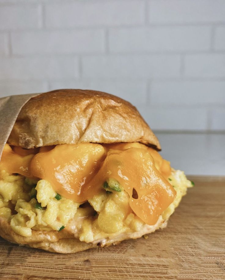 an egg and cheese sandwich on a wooden table