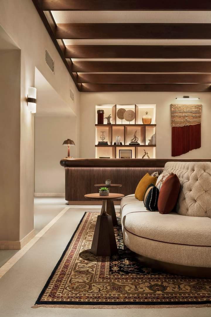 a living room filled with furniture and lots of bookshelves on top of shelves